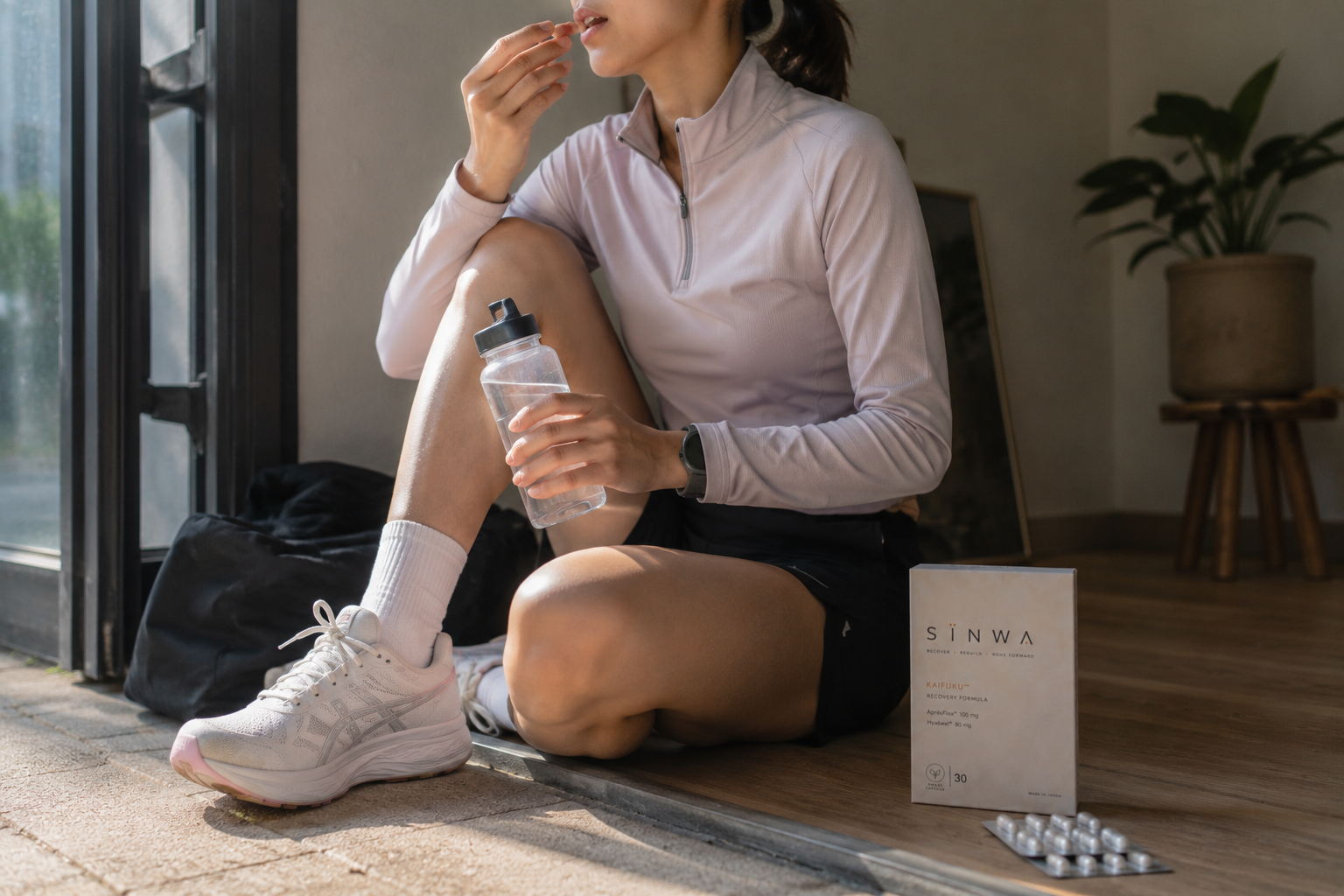 Runner taking SINWA Recovery capsule after workout — the daily ritual