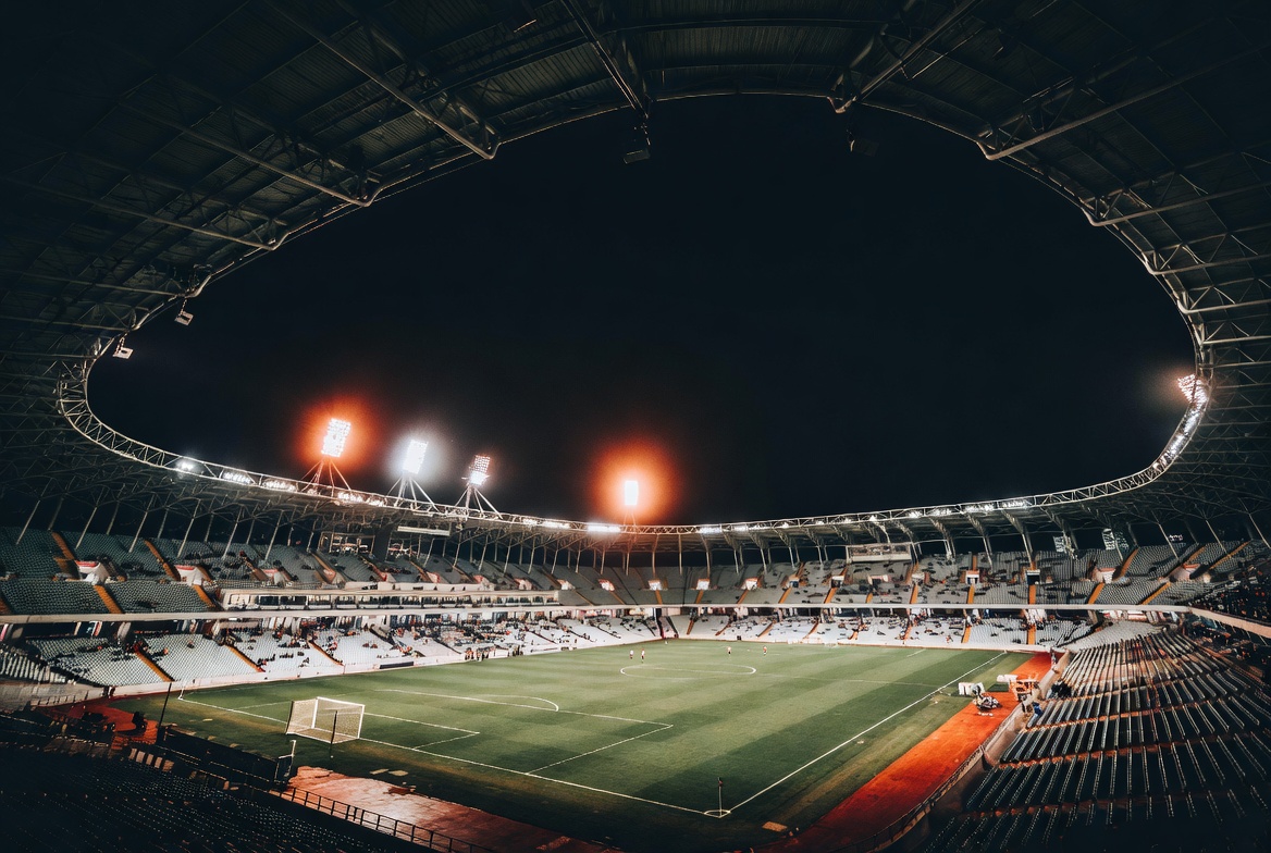 PSG vs Inter Milan — night stadium aerial view with glowing pitch lights