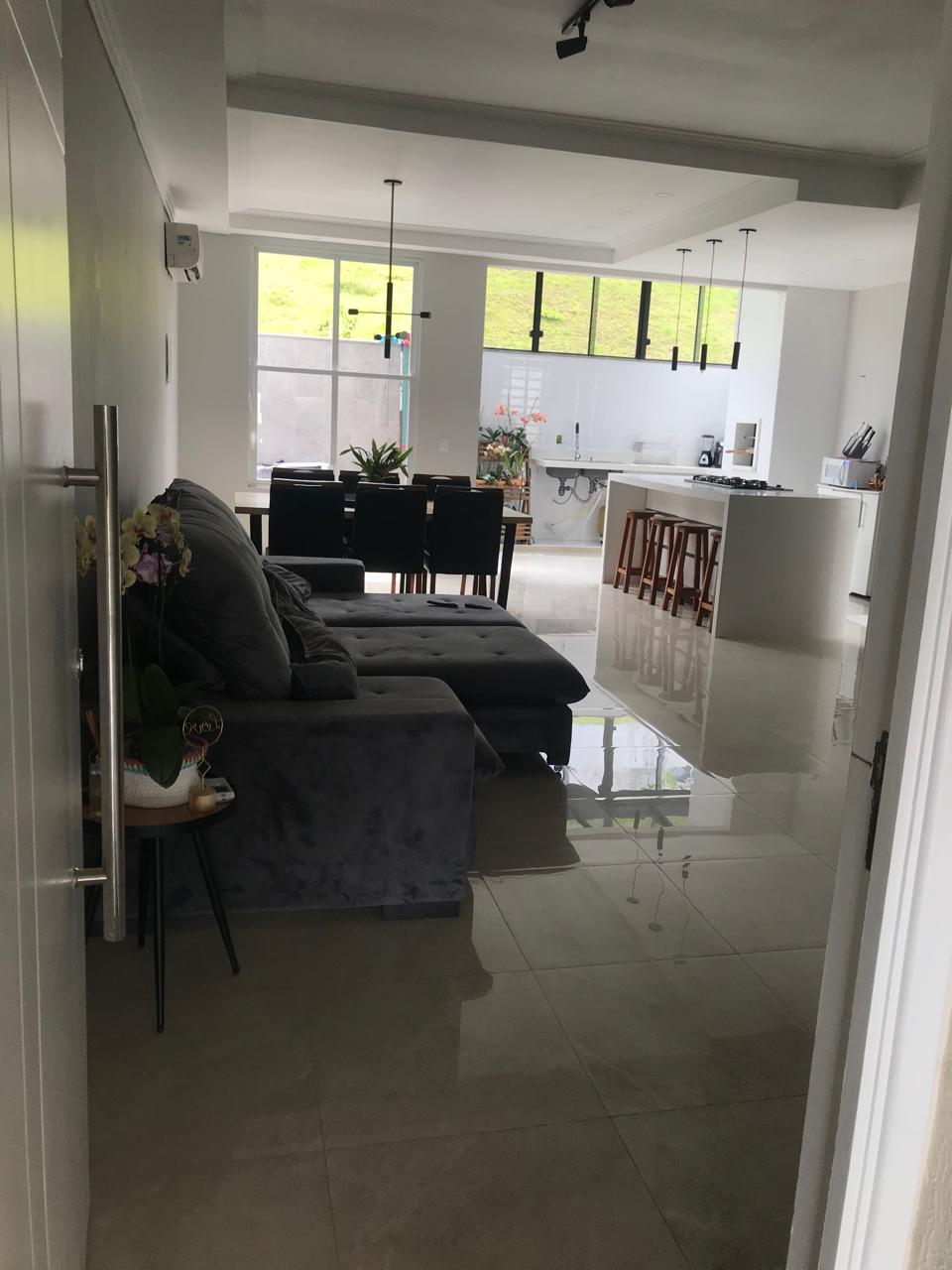 Sala e cozinha integradas com piso porcelanato e ilha gourmet