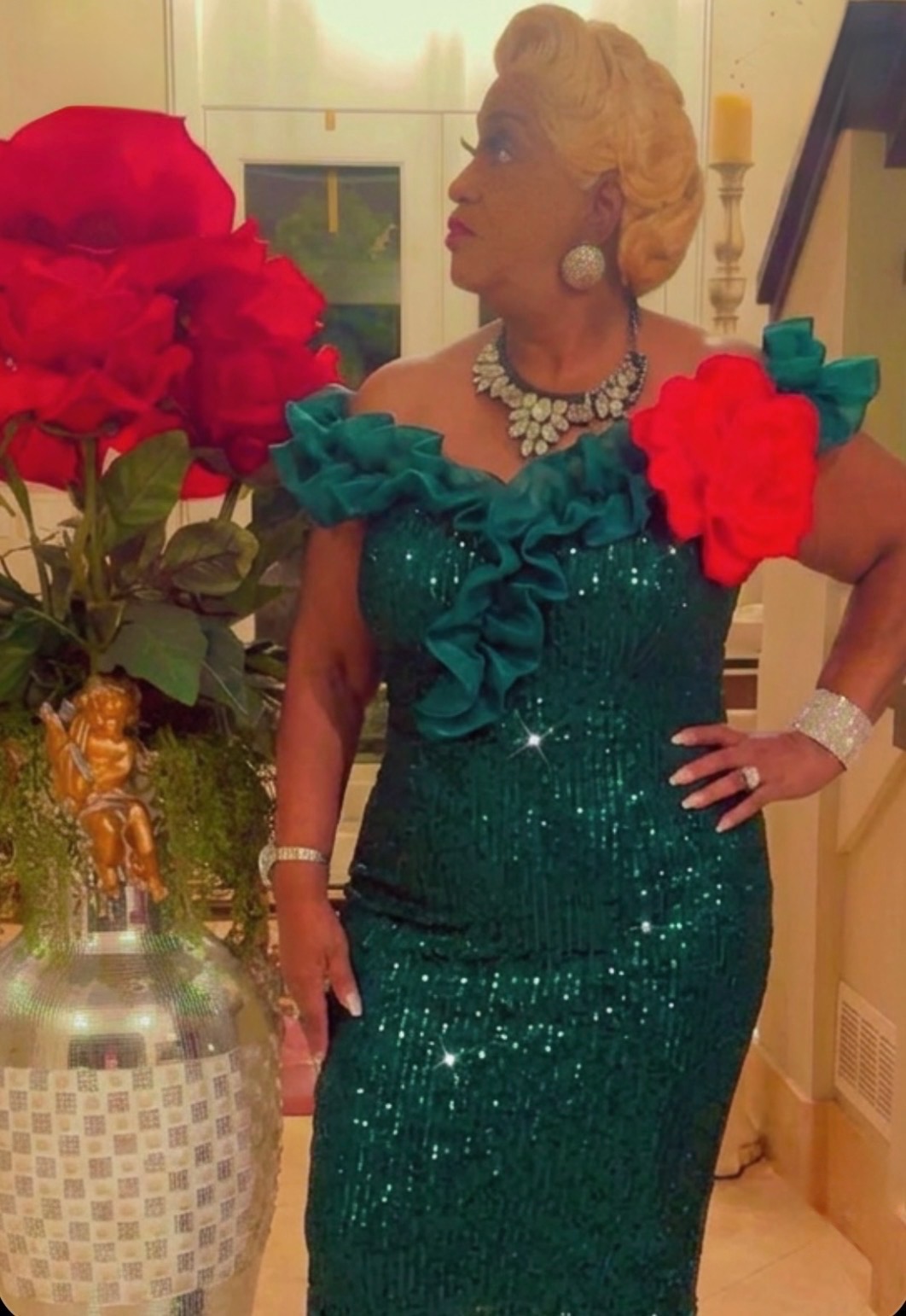 Dr. Sunshine Lewis at gala event in emerald green sequin gown