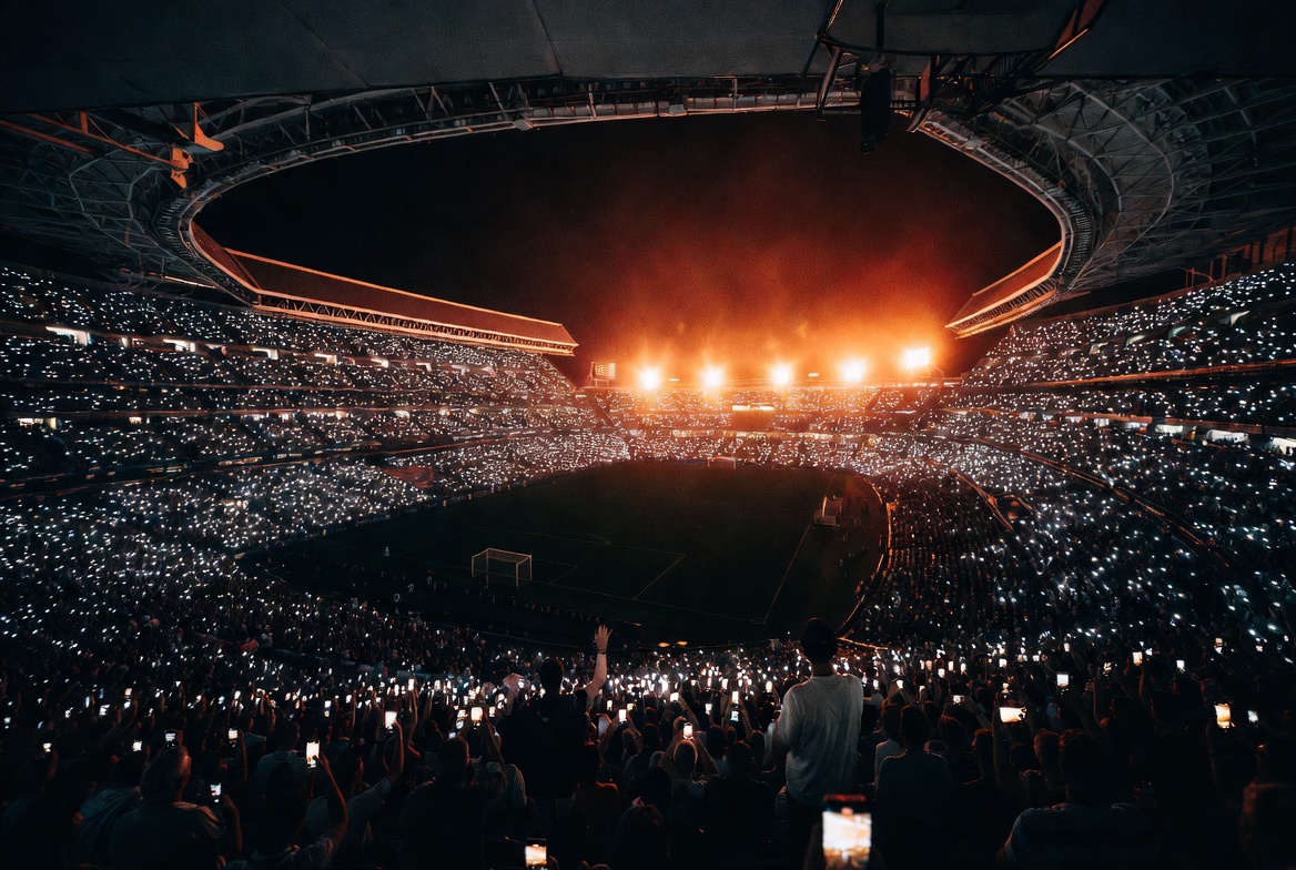 Real Madrid vs Manchester City — packed stadium with orange floodlights