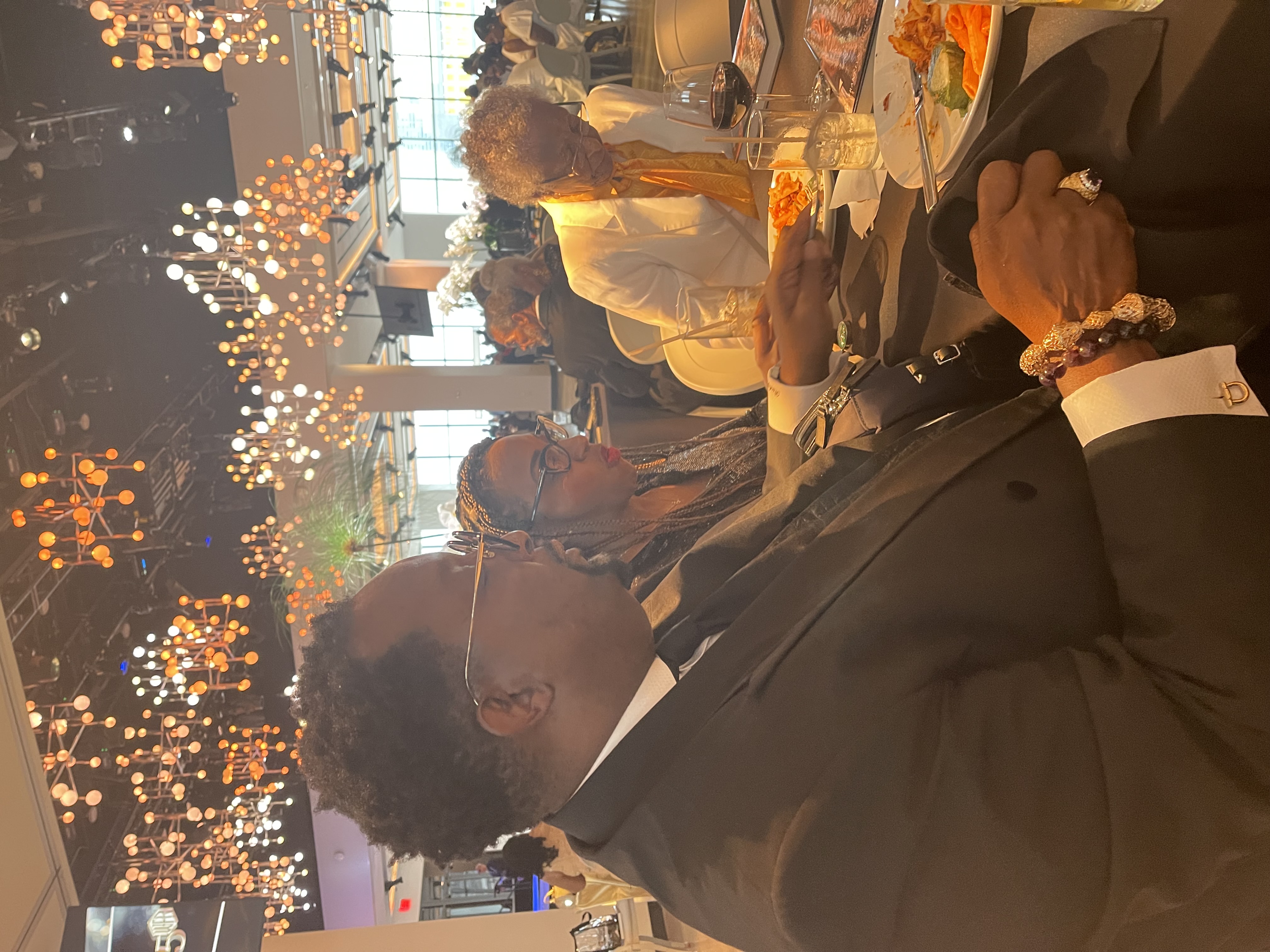 WFR Fifty Years gala dinner — VIP guests at elegantly set tables beneath spectacular chandeliers
